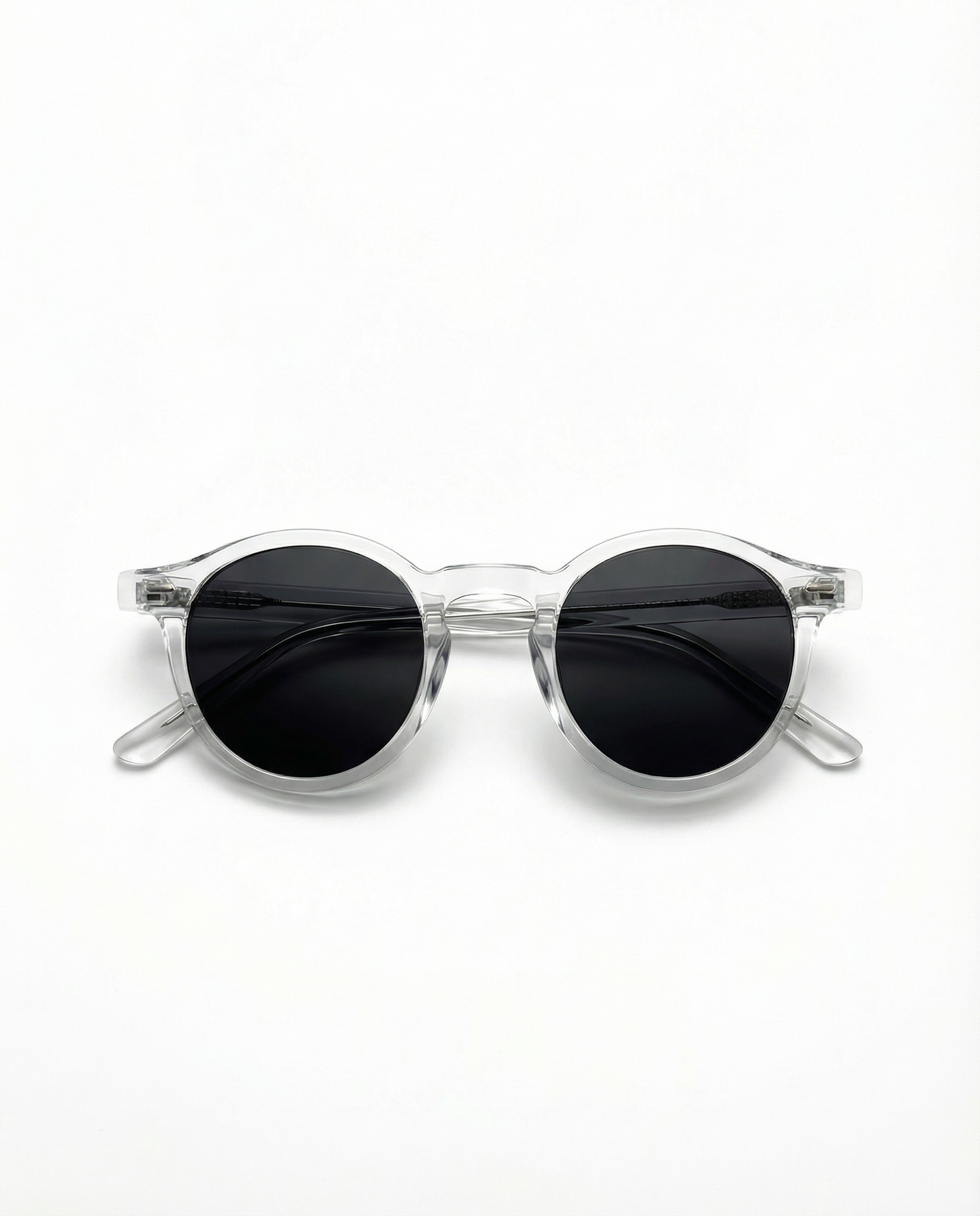 Clear frame sunglasses with black lenses on a white background