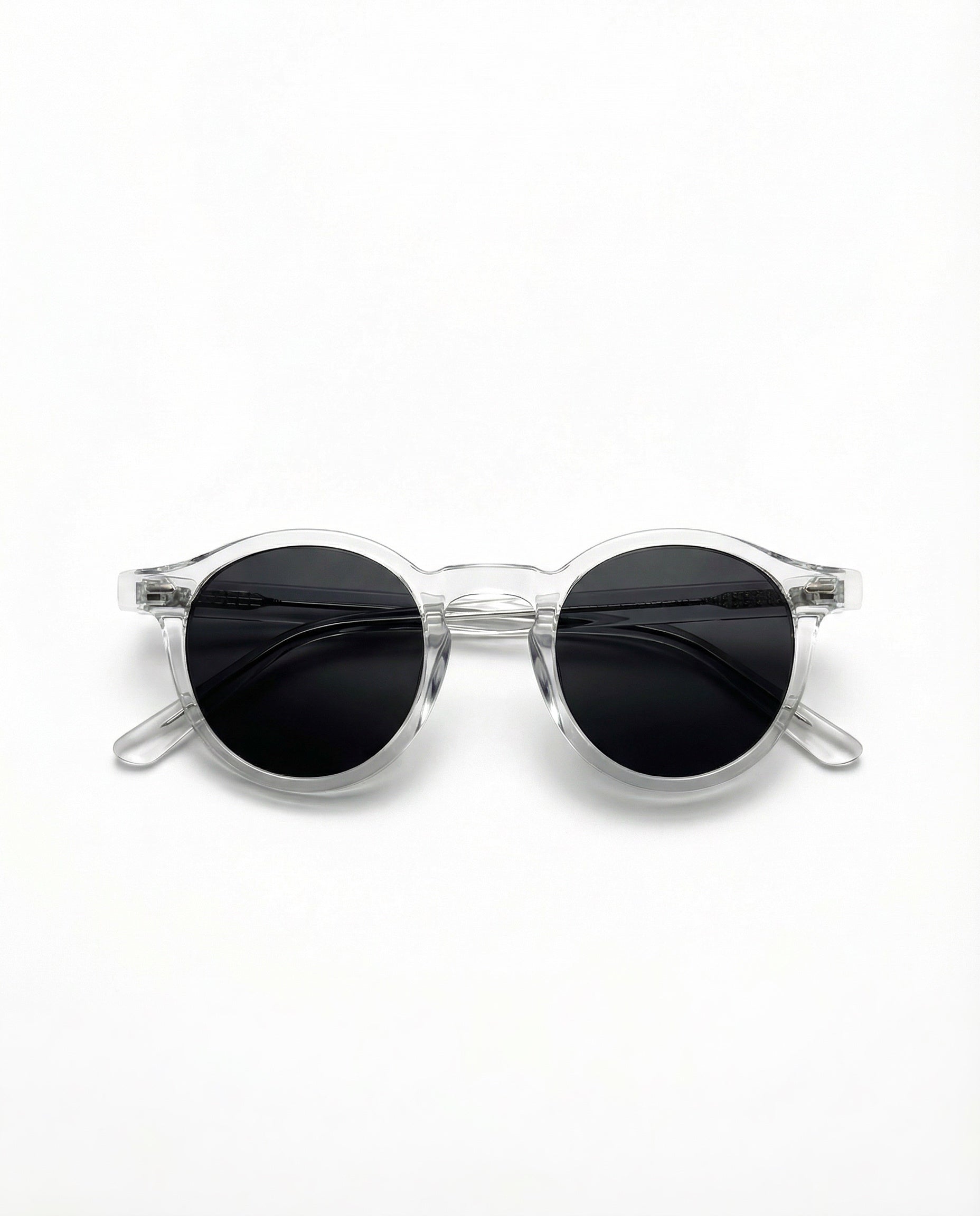 Clear frame sunglasses with black lenses on a white background