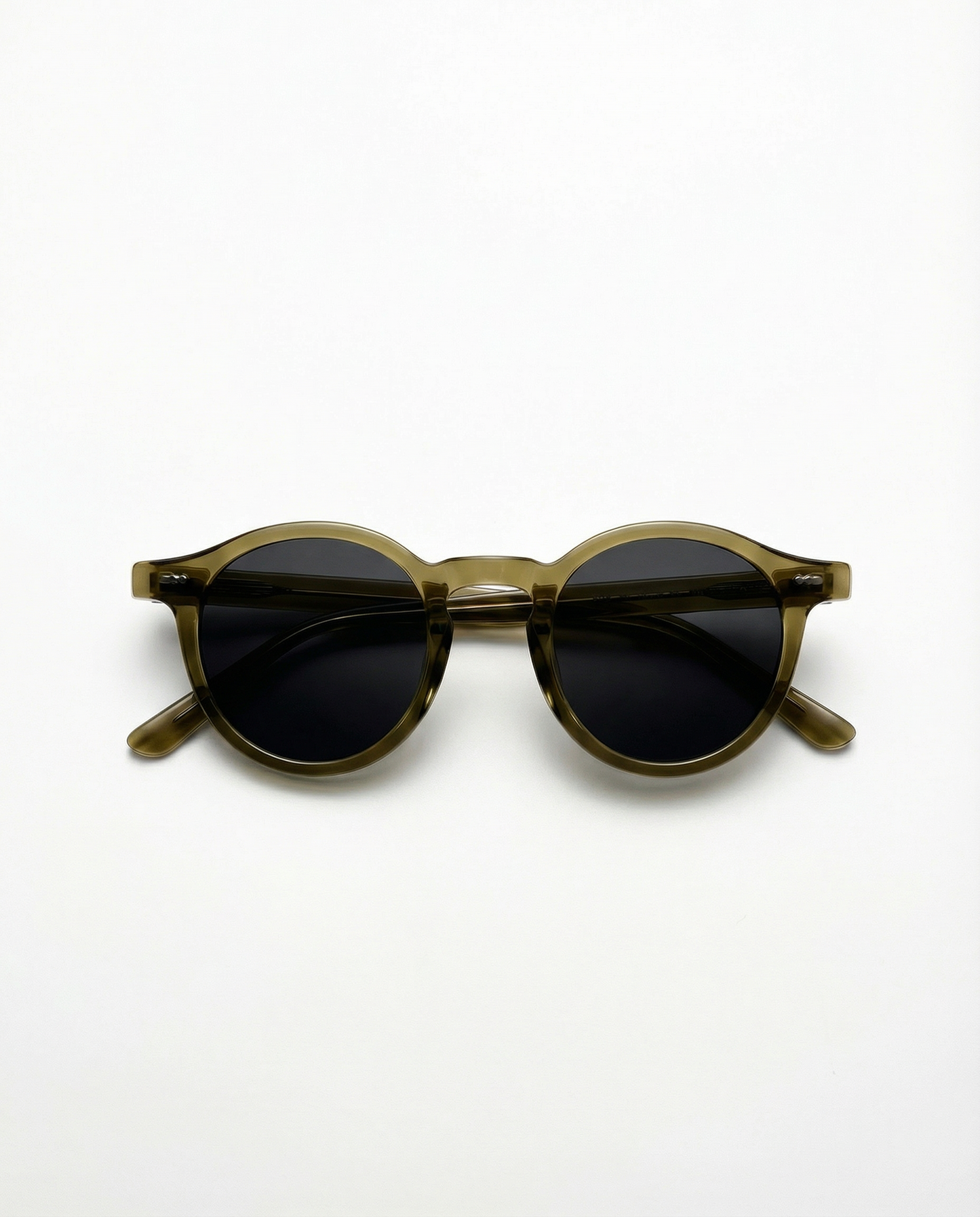 Round sunglasses with dark lenses and brown frame on a white background